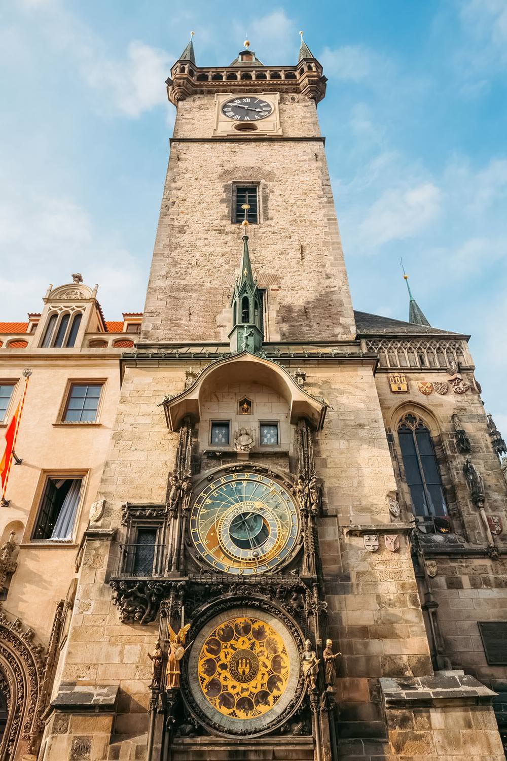 Close-up of the Prague Astronomical Clock and the Old Town Hall tower against a clear sky